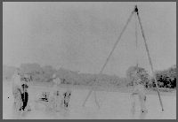 A gin pole or tripod set up to cable tool a well or work over a well.